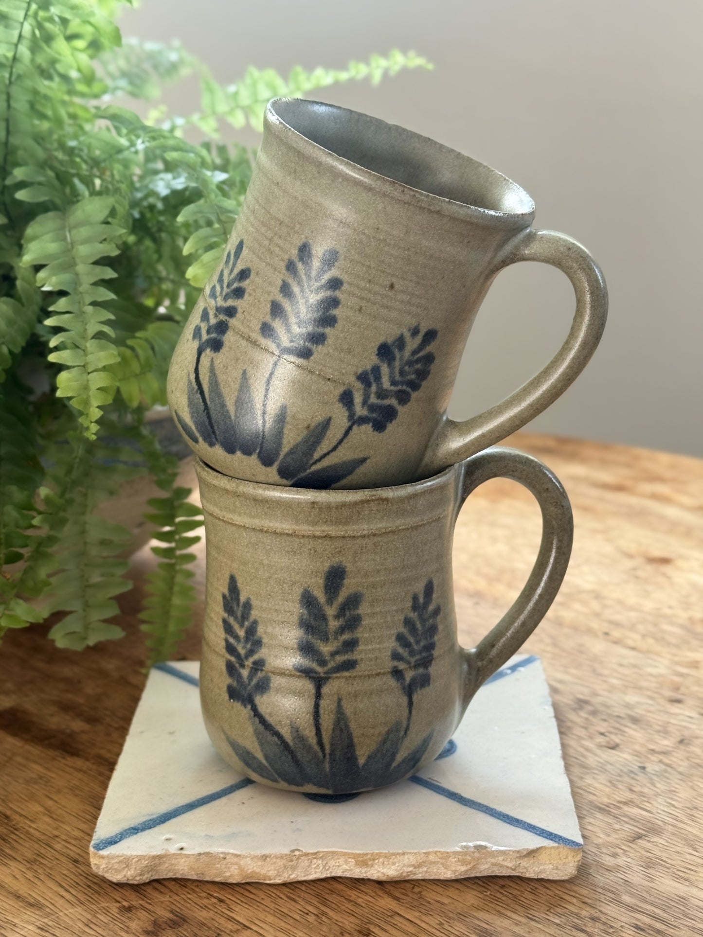 Pair of Hand-Thrown Studio Pottery Mugs, Wheat Motif in Blue on Oat Glaze