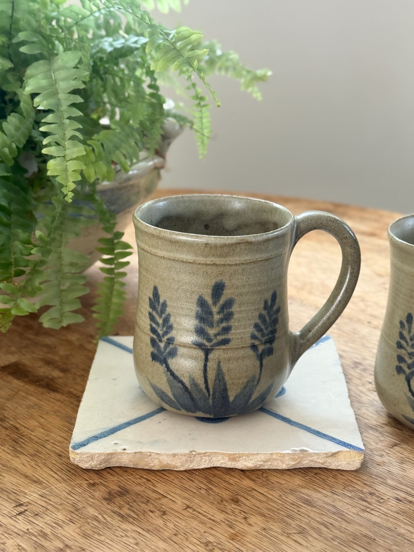 Pair of Hand-Thrown Studio Pottery Mugs, Wheat Motif in Blue on Oat Glaze
